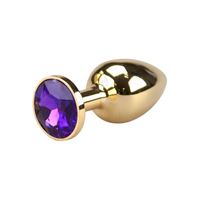 Bild von Glatter goldener Buttplug mit violettem Kristall